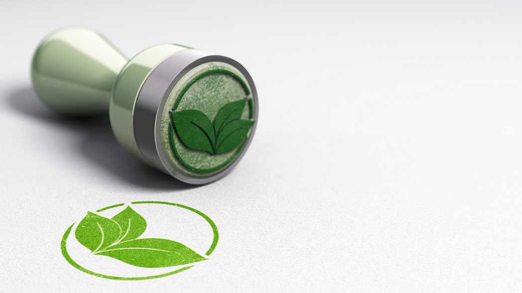 Ein Stempel mit grünem Blättersymbol.